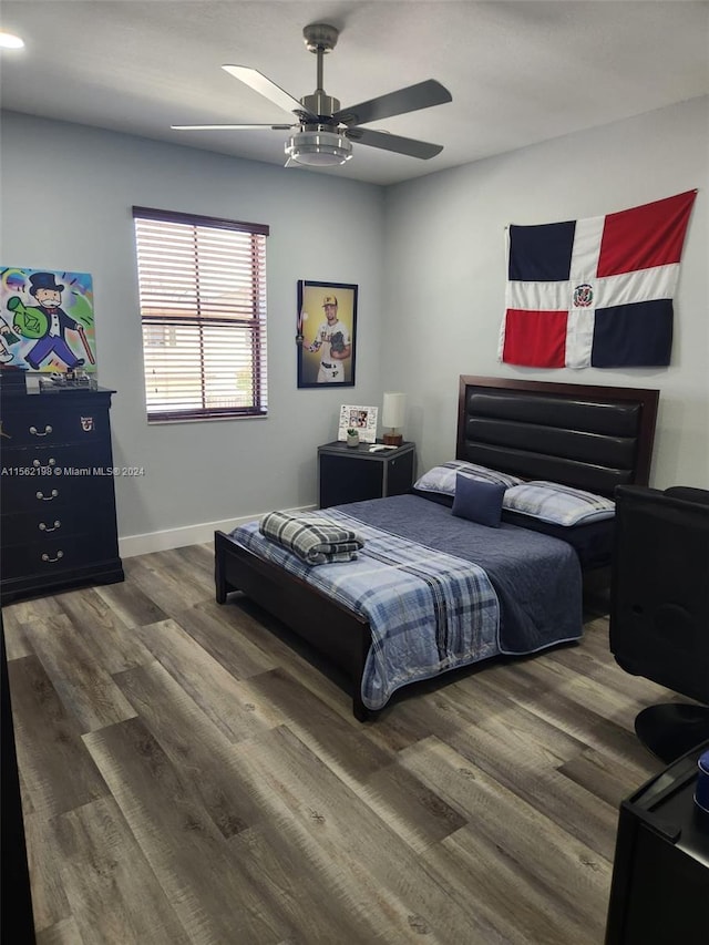 bedroom with ceiling fan and dark wood-type flooring