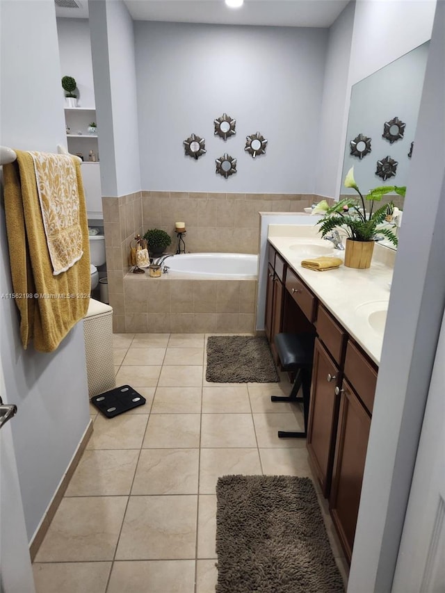 bathroom featuring dual bowl vanity, tile floors, and tiled tub