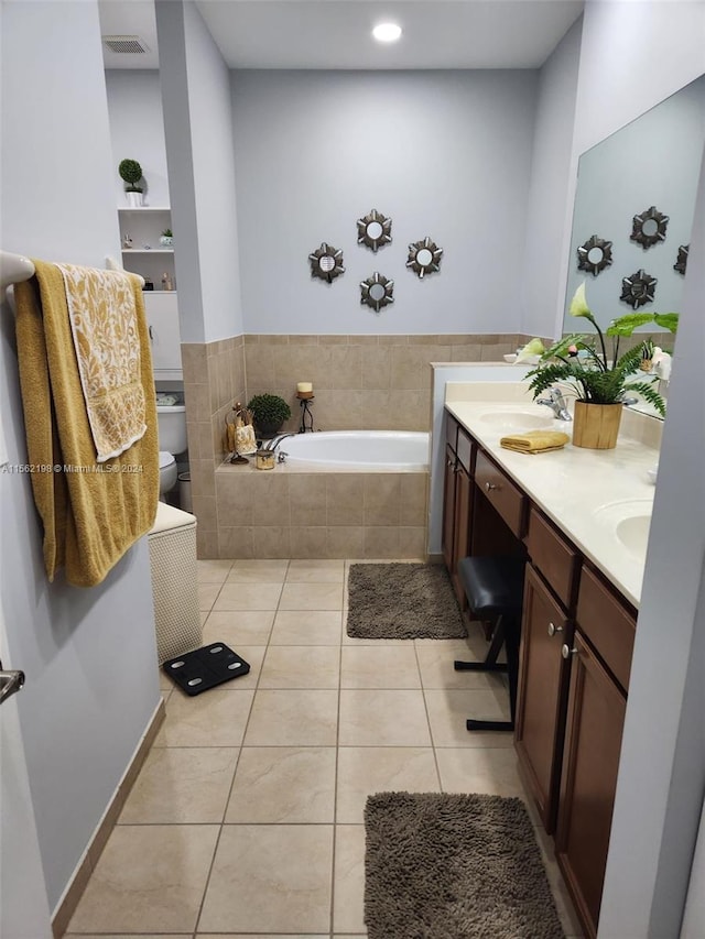 bathroom with a relaxing tiled bath, tile floors, and double vanity