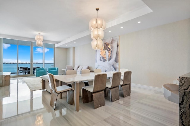 tiled dining area with expansive windows and a water view