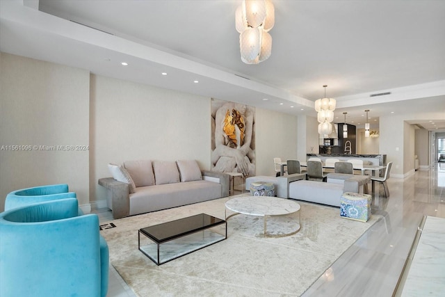 living room with light tile floors and a notable chandelier