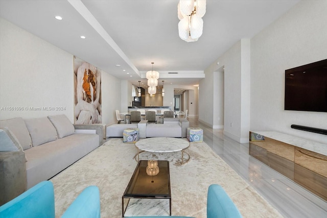 living room featuring light tile floors and an inviting chandelier