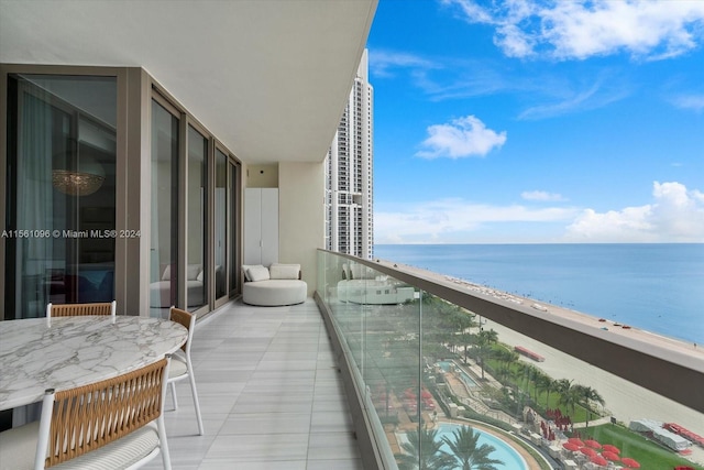 balcony with a water view and a beach view