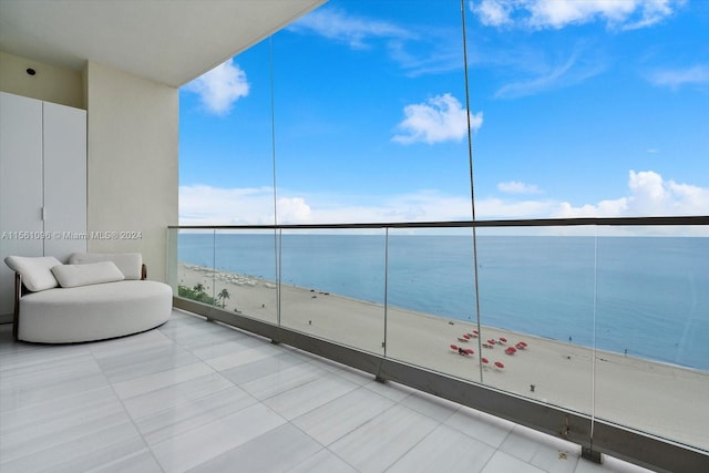 balcony featuring a water view and a view of the beach