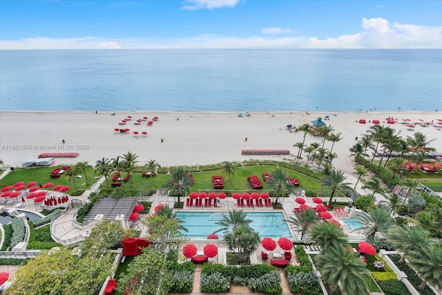 birds eye view of property with a beach view and a water view