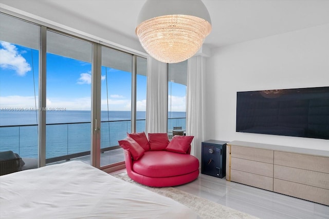 bedroom with an inviting chandelier, access to exterior, and a water view