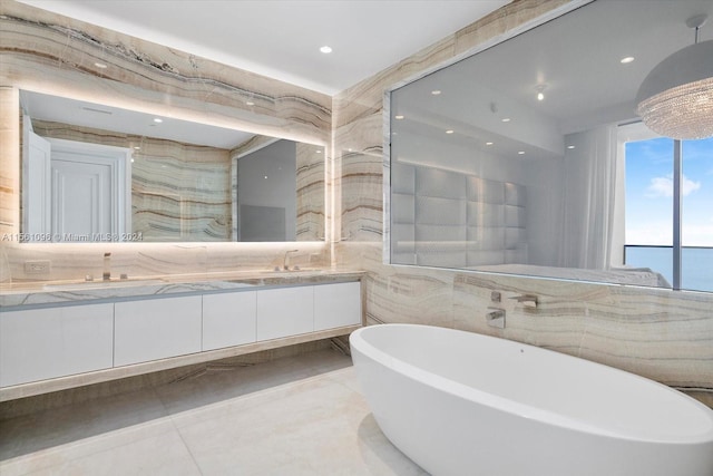 bathroom featuring tile walls, double sink vanity, and tile flooring