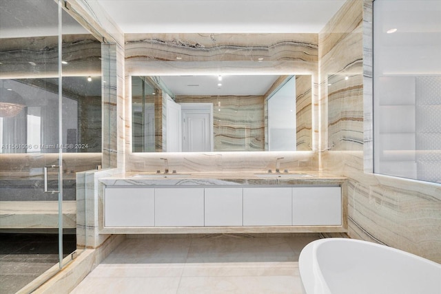 bathroom featuring oversized vanity, tile floors, dual sinks, and tile walls