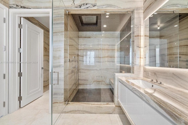 bathroom with tile floors, large vanity, and walk in shower