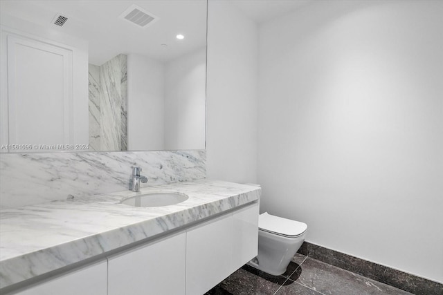 bathroom with tile floors, toilet, and vanity