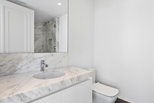 bathroom featuring toilet and vanity