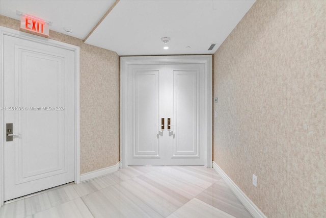 hallway with light tile floors