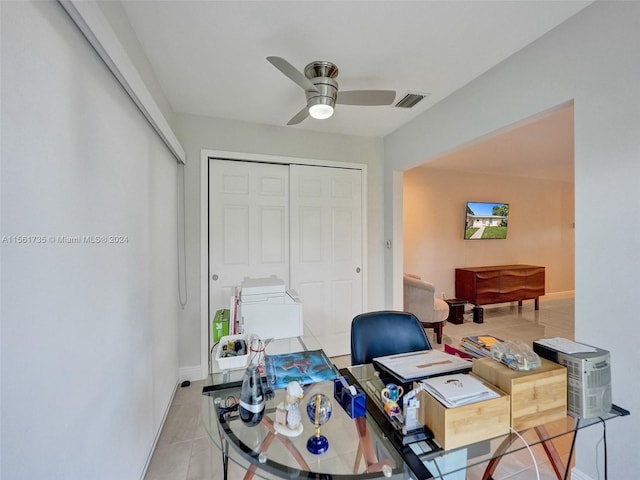 tiled office space with ceiling fan