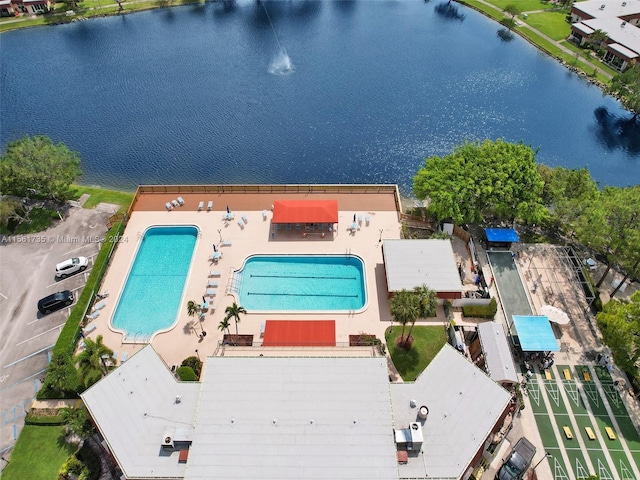 birds eye view of property with a water view