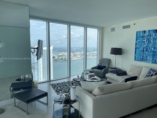 living room featuring floor to ceiling windows and a water view