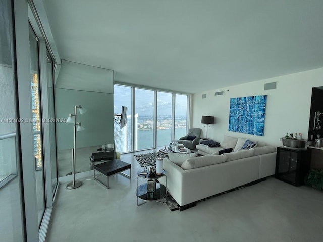 living room with a water view and a wall of windows