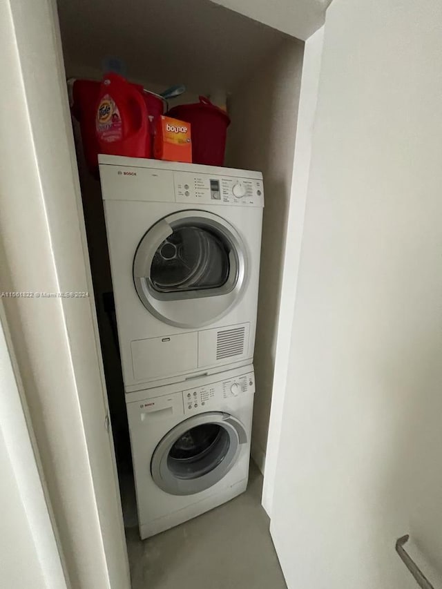 laundry area with stacked washer / drying machine