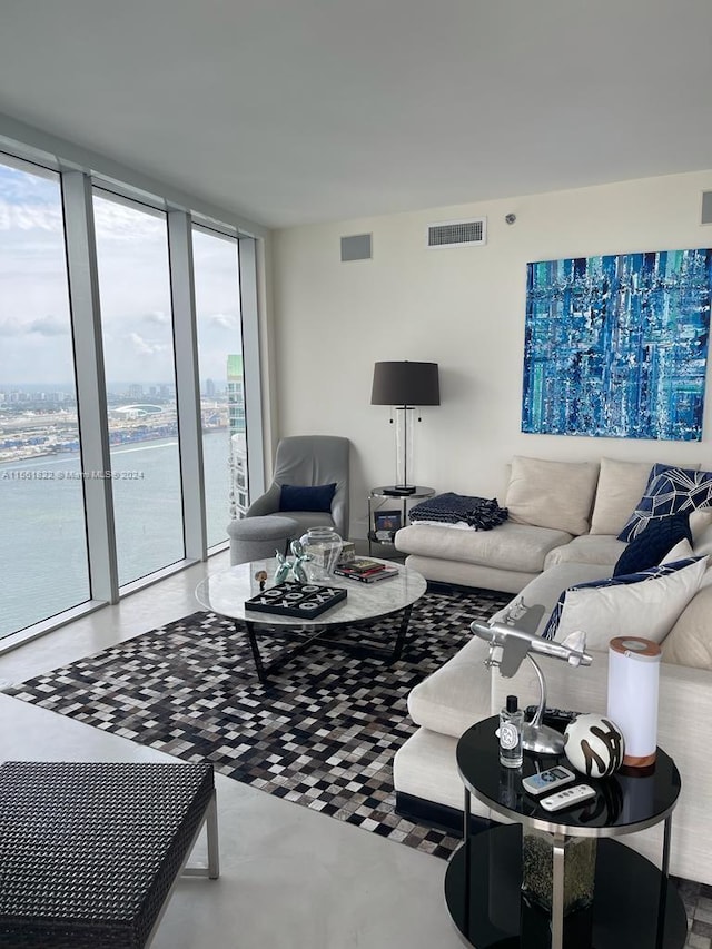 living room with floor to ceiling windows and a water view