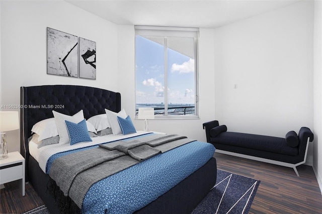 bedroom with dark wood-type flooring