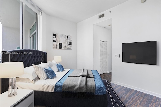 bedroom with dark hardwood / wood-style flooring