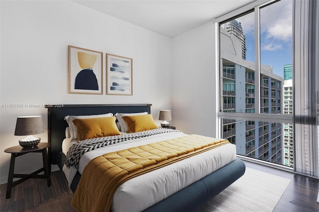 bedroom featuring floor to ceiling windows and dark wood-type flooring