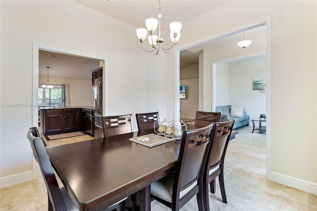 dining area with light tile floors and a chandelier