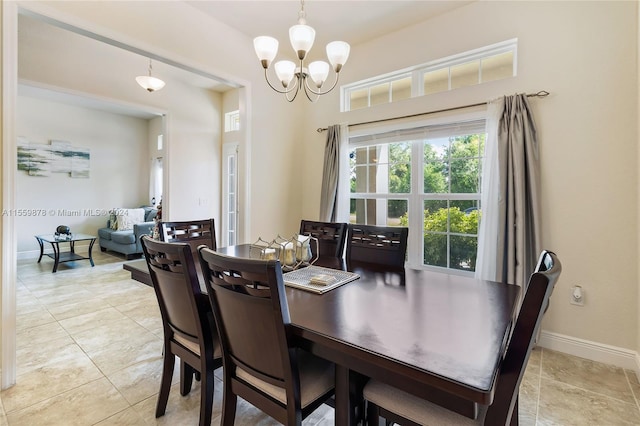 tiled dining space featuring a chandelier