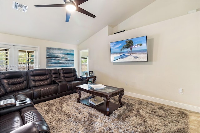 living room with vaulted ceiling, ceiling fan, and french doors