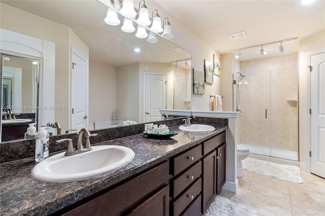 bathroom with toilet, rail lighting, a shower with door, tile floors, and dual vanity