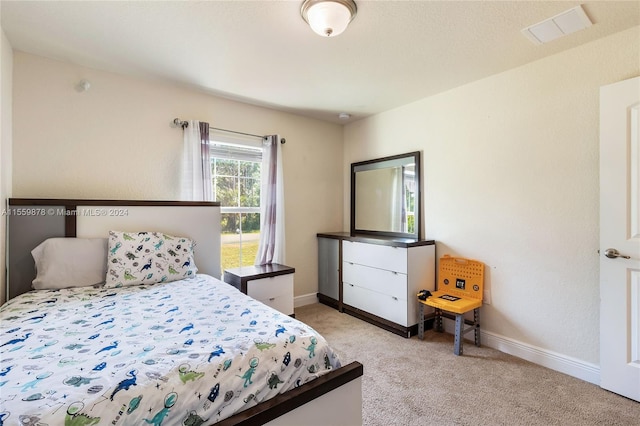 bedroom featuring light colored carpet