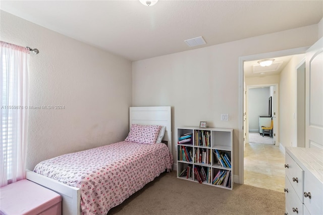 bedroom with light colored carpet