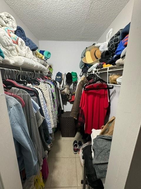 walk in closet featuring light tile floors