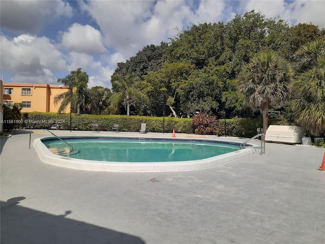 view of swimming pool with a patio