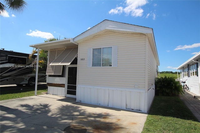 view of home's exterior with a carport