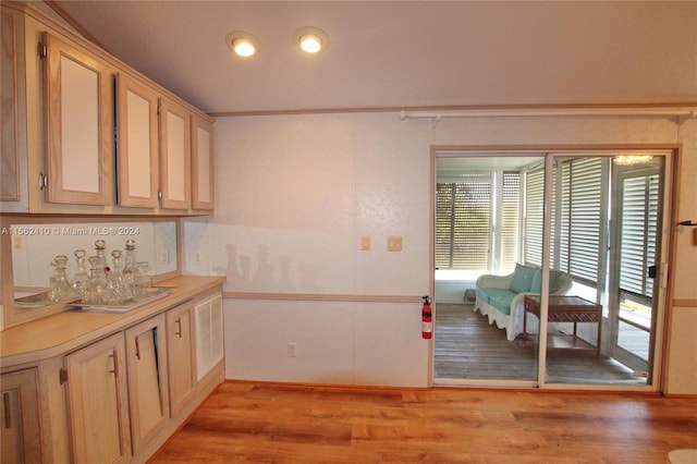 kitchen featuring light hardwood / wood-style flooring and crown molding