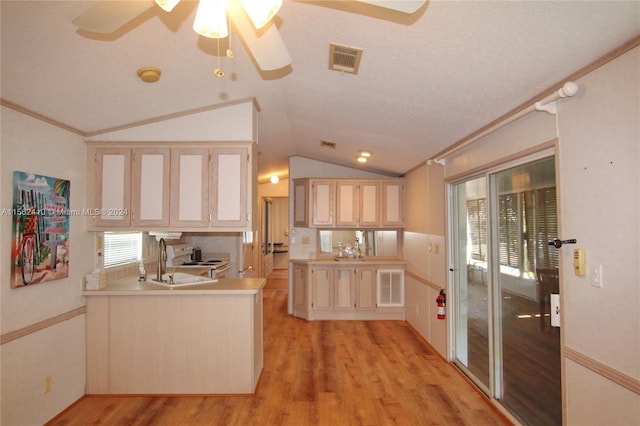 kitchen with lofted ceiling, ceiling fan, light hardwood / wood-style floors, and crown molding