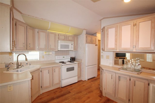 kitchen with white appliances, light brown cabinets, sink, light hardwood / wood-style floors, and lofted ceiling