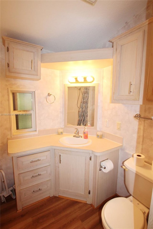 bathroom with oversized vanity, hardwood / wood-style flooring, and toilet