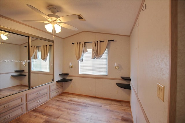 interior space with hardwood / wood-style floors, vaulted ceiling, and ceiling fan