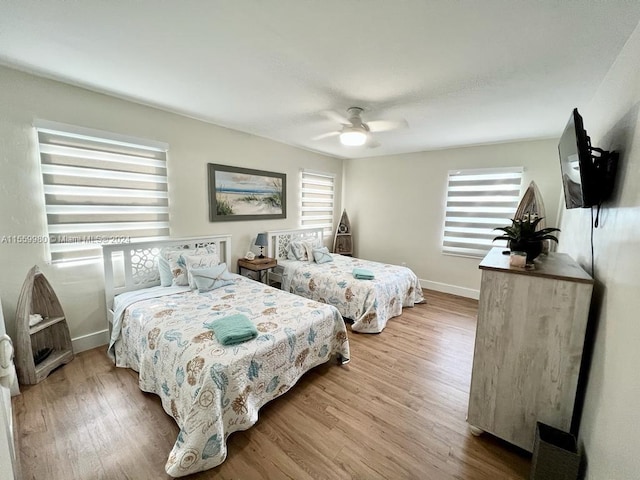 bedroom with ceiling fan and light wood-type flooring