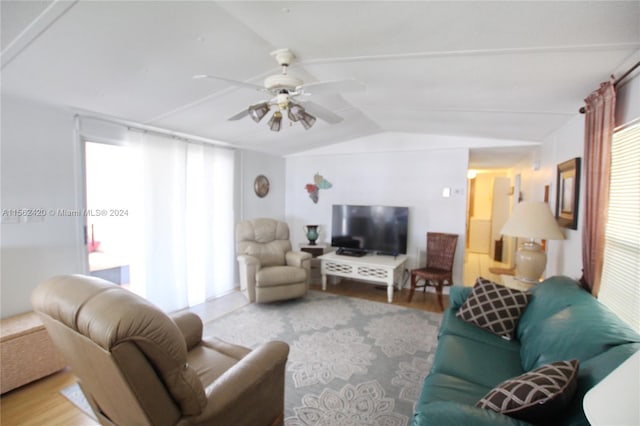 living room featuring vaulted ceiling, ceiling fan, and light wood-type flooring