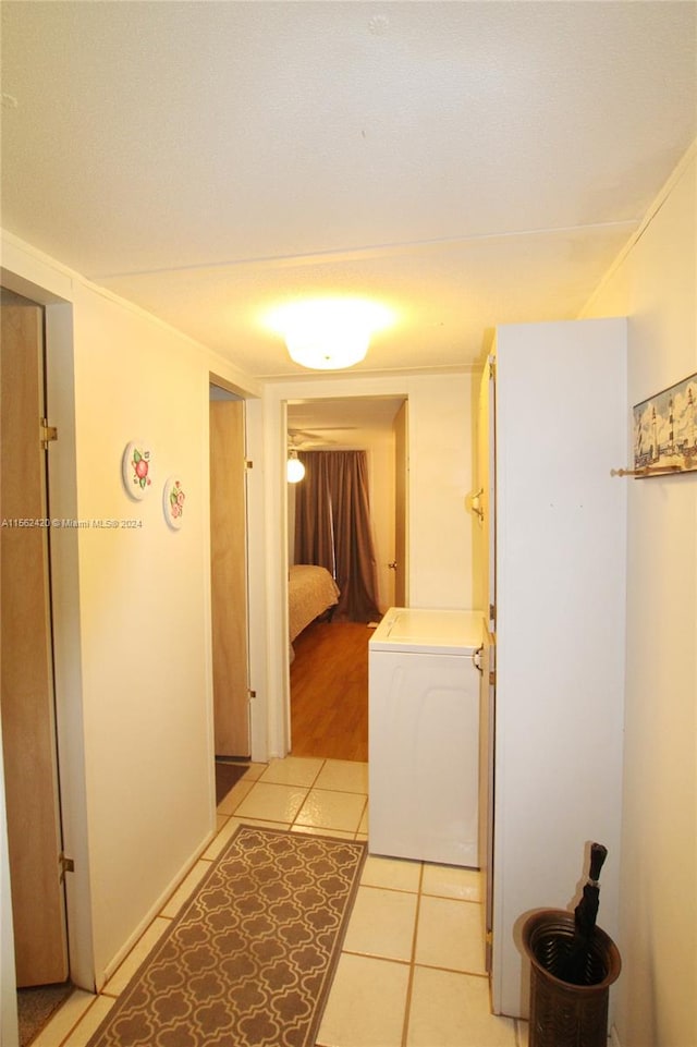 laundry room featuring light tile floors and washer / clothes dryer