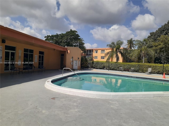 view of swimming pool with a patio