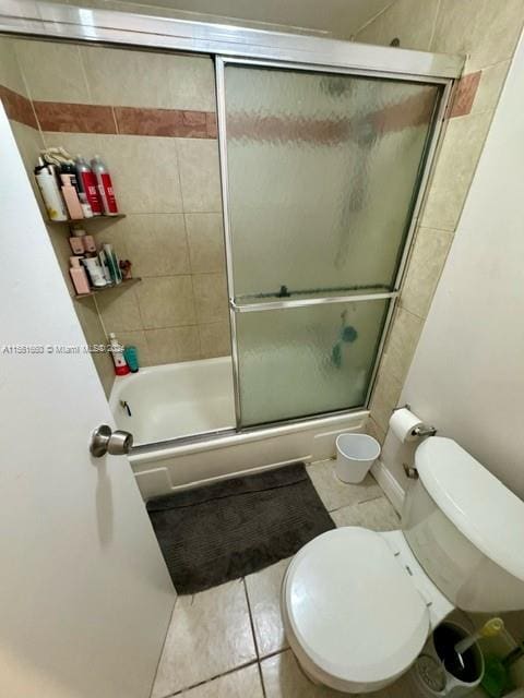 bathroom featuring tile flooring and toilet