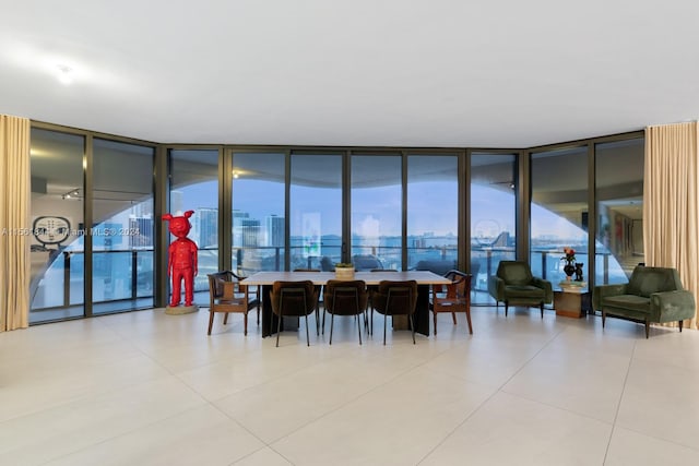 tiled dining space featuring a wall of windows