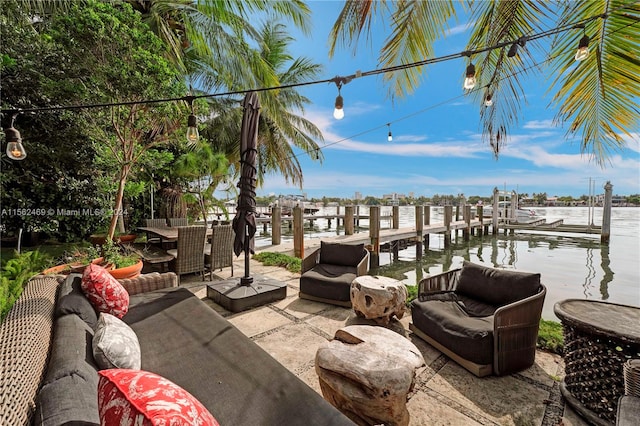 view of patio featuring a water view and a dock