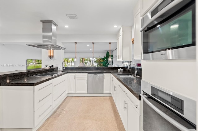 kitchen featuring kitchen peninsula, stainless steel appliances, island range hood, sink, and white cabinets