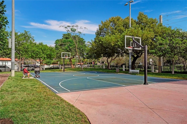 view of sport court featuring a lawn