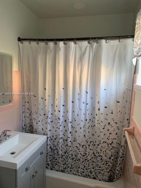 bathroom featuring shower / tub combo with curtain and vanity