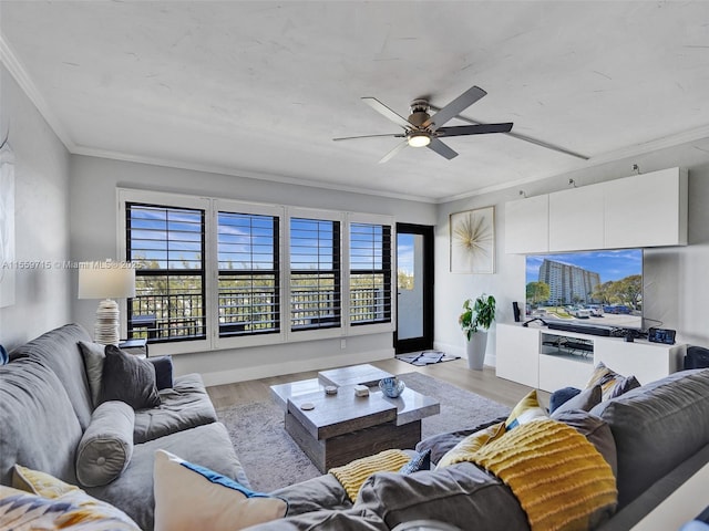 living room with light wood-type flooring, ceiling fan, and crown molding